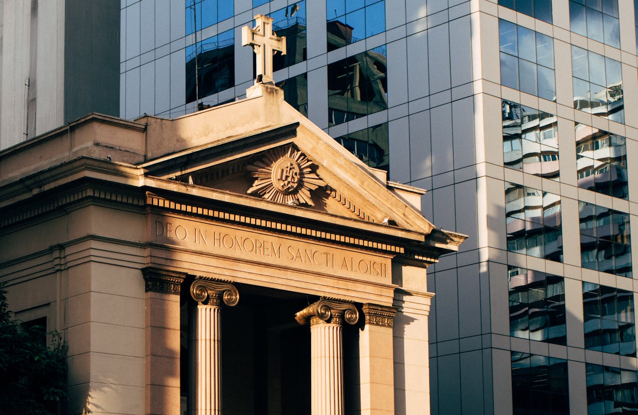 A historic church facade beautifully contrasted against a modern skyscraper backdrop, highlighting architectural diversity.